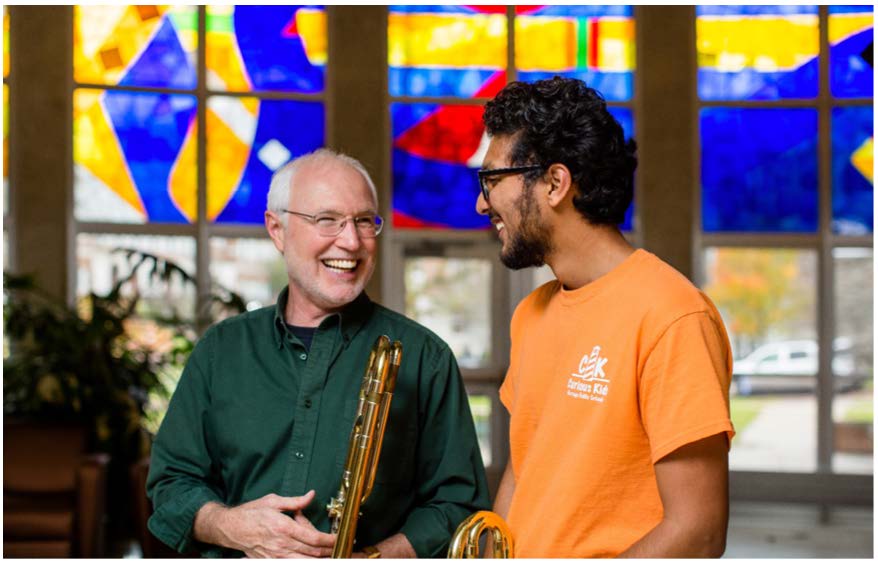 Music professor laughs with student